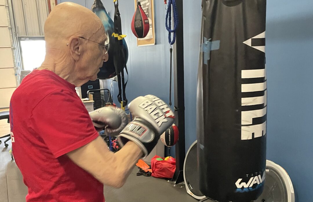 A man uses a heavy bag.