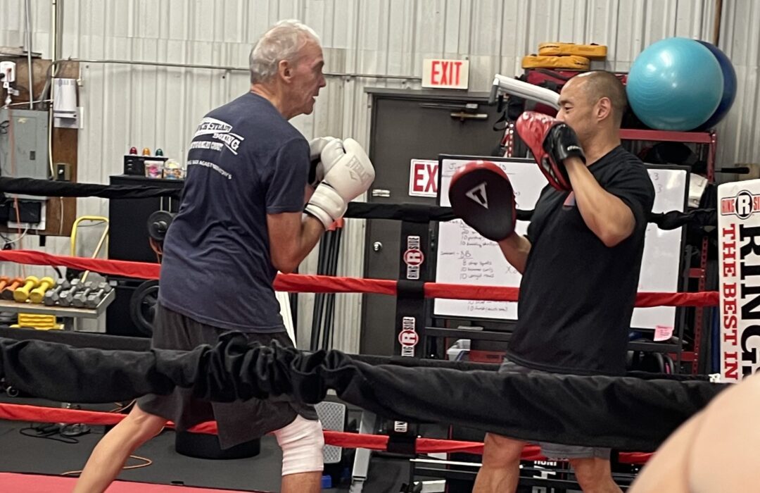 Two men spar in the ring.